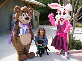 Marikay and Cynthia with 2 amusement park costumed people. A brown bear with a purple cape and white rabbit in a red dress.