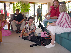 The three puppy raisers sitting in lounge talking to Cynthia and Justin.